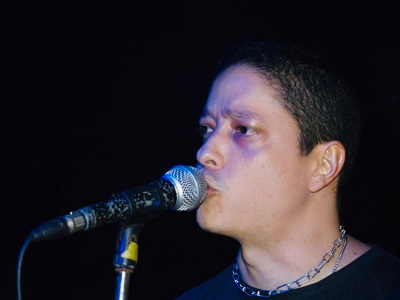 Banda Artificial em ação no palco — guitarrista e baixista em movimento.